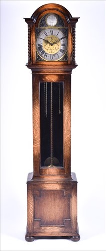 Lot 384 - An early 20th century oak longcase chiming...