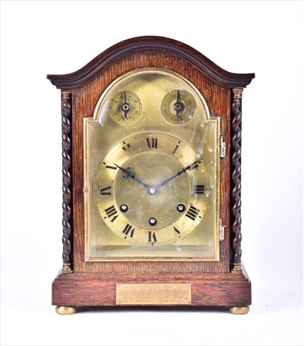 Lot 375 - An early 20th century oak cased mantel clock...