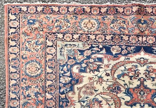 Lot 71 - A hand woven Isfahan rug with central floral...