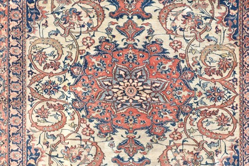 Lot 71 - A hand woven Isfahan rug with central floral...