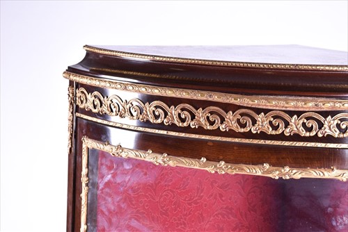 Lot 42 - A French Louis XV style corner vitrine cabinet...