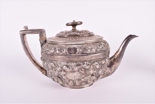 Lot 466 - A Georgian silver teapotÂ with later embossed...