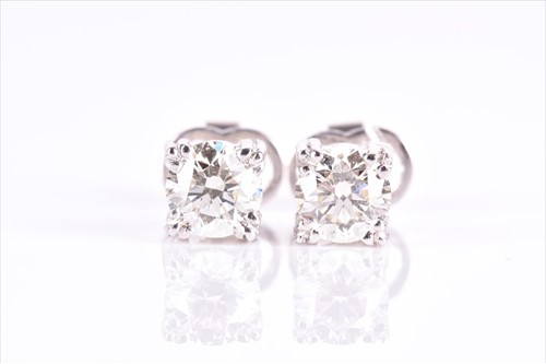 Lot 585 - A pair of solitaire diamond earrings the...