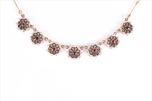Lot 607 - A yellow metal, enamel and ruby necklace set...