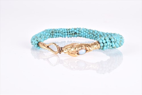 Lot 608 - An unusual yellow metal and turquoise bangle...