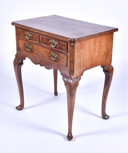 Lot 4 - A Queen Anne walnut lowboy with quarter...