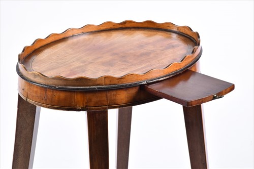 Lot 61 - A small George III oval wine table with wave...