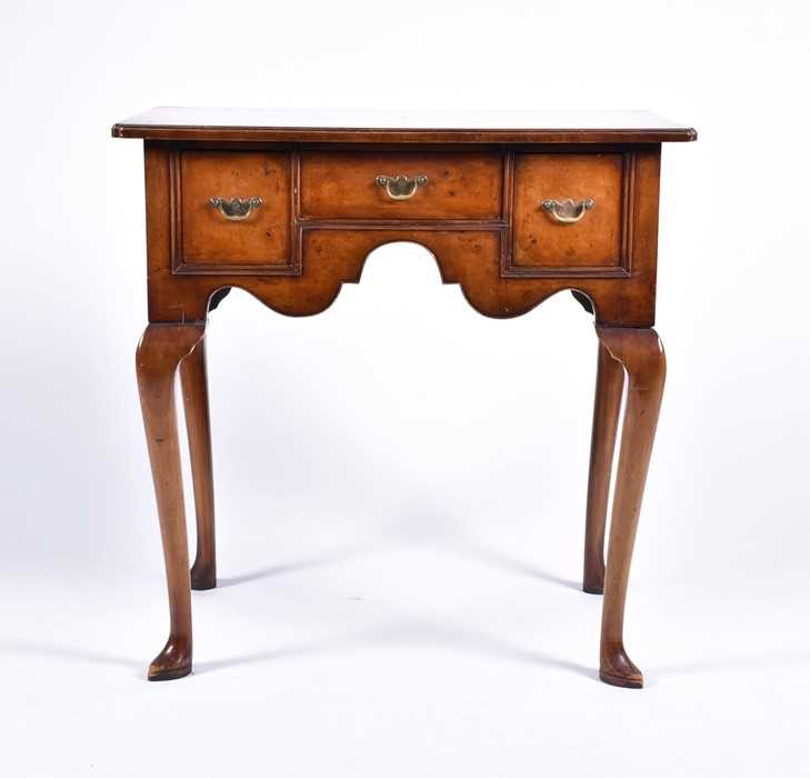 Lot 58 - A reproduction burr walnut lowboy the...