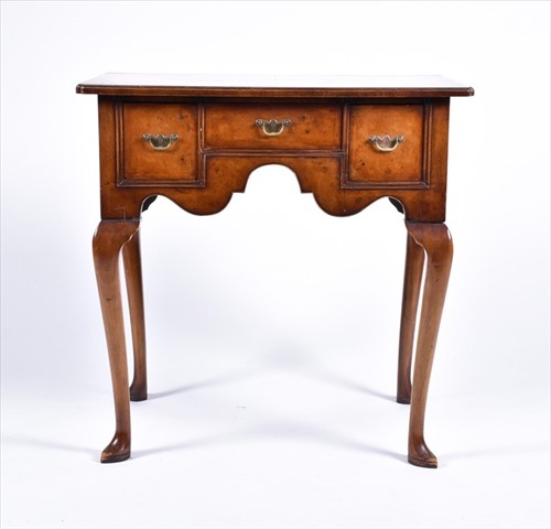 Lot 58 - A reproduction burr walnut lowboy the...