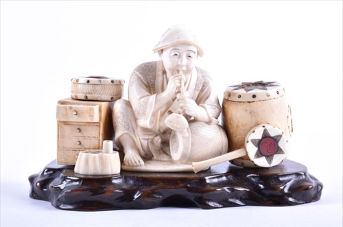 Lot 251 - A Japanese Meiji period ivory okimono...