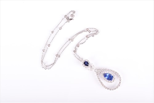 Lot 577 - An 18ct white gold, diamond, and sapphire...
