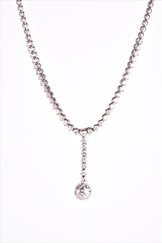 Lot 576 - An 18ct white gold and diamond drop pendant...