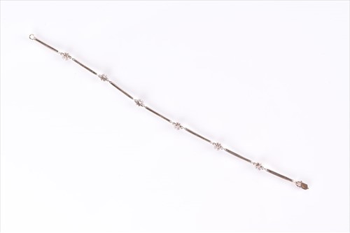 Lot 568 - A white metal and diamond bracelet set with...