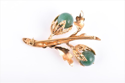 Lot 571 - A yellow metal and jadeite brooch of foliate...