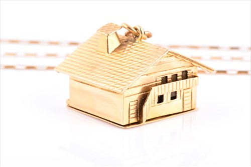 Lot 581 - An unusual 18ct gold miniautre music box charm...