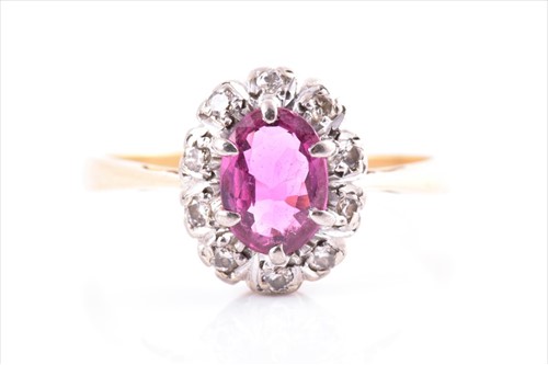 Lot 568 - A yellow gold, diamond, and ruby ring of oval...