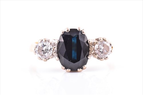 Lot 561 - A diamond and sapphire three stone ring...