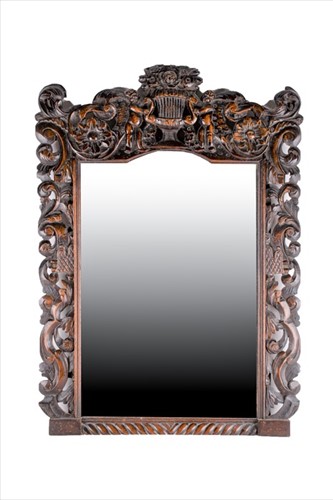 Lot 123 - A 19th century oak carved mirror with figural...