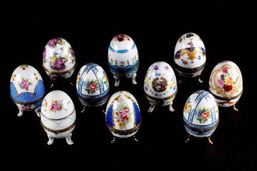 Lot 185 - A collection of eight porcelain egg trinket...