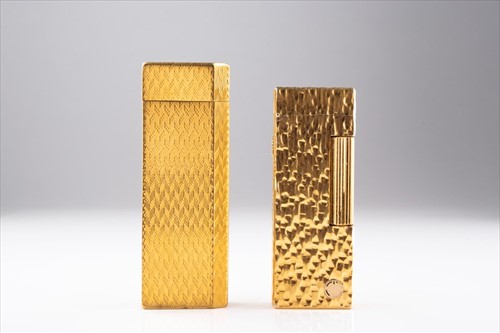 Lot 245 - A gold plated Cartier cigarette lighter and a...