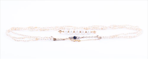 Lot 566 - A triple strand pearl necklace comprised of...