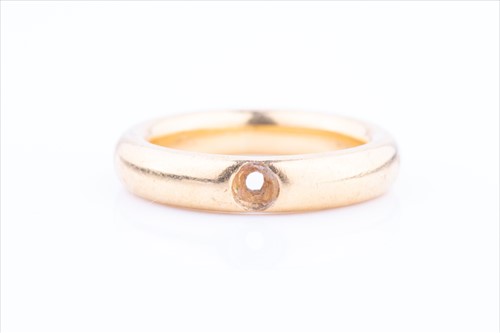 Lot 554 - A yellow metal rounded band ring (lacking...