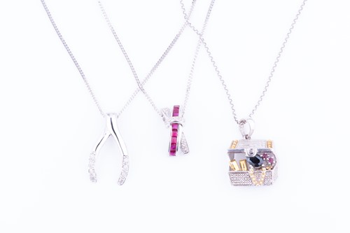 Lot 525 - Two gem set 9 carat white gold pendants...