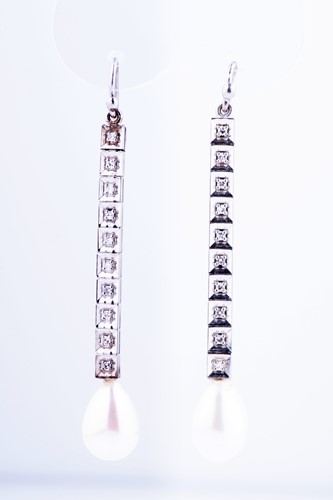Lot 547 - A pair of diamond and pearl pendant earrings...