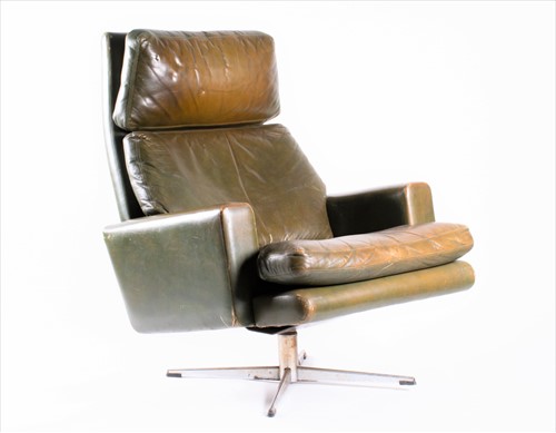 Lot 140 - A 1970s green leather upholstered armchair...