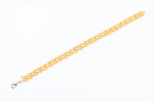 Lot 428 - A yellow metal fancy-link chain bracelet with...
