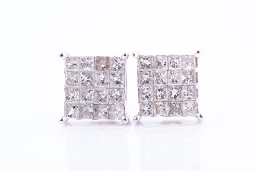 Lot 447 - A pair of white metal and diamond earrings of...