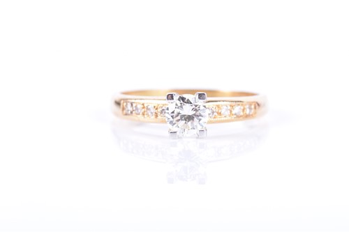Lot 818 - An 18ct yellow gold and diamond ring centred...