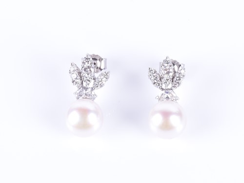 Lot 7 - A pair of diamond and pearl earrings the...