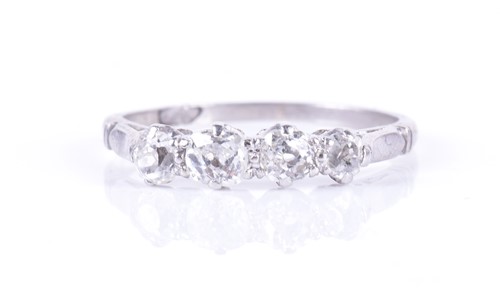 Lot 20 - A four-stone diamond ring set with four...