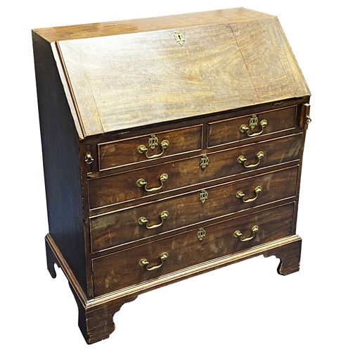 Lot 517 - A George III mahogany bureau, the fall front...