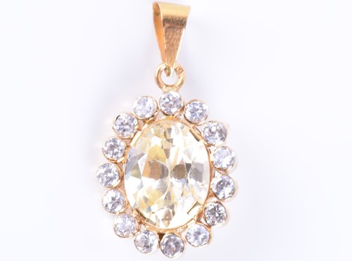 Lot 79 - A synthetic yellow sapphire pendant set with a...
