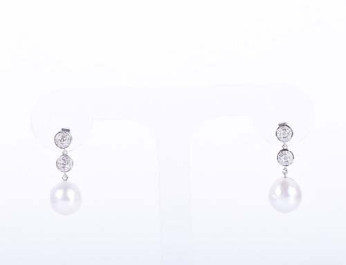Lot 84 - A pair of diamond and pearl drop earrings each...