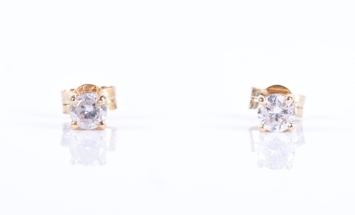 Lot 144 - A pair of solitaire diamond ear studs the...