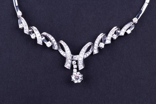 Lot 411 - An 18ct white gold and diamond necklace...