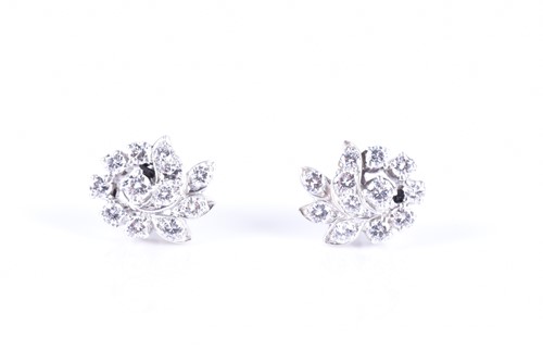 Lot 286 - A pair of diamond swirl cluster earrings set...