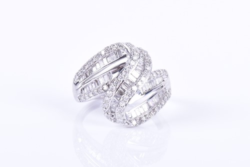 Lot 289 - A white gold and diamond swirled crossover...