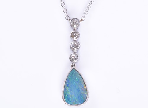 Lot 322 - An 18ct white gold, diamond, and opal pendant...