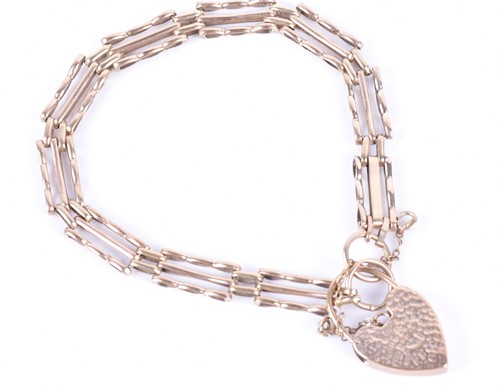 Lot 348 - A 9ct yellow gold gate-link bracelet fastened...