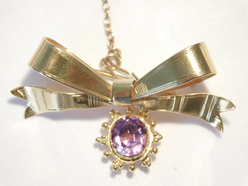Lot 350 - A 9ct gold bow brooch with amethyst pendant...