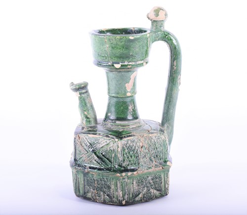 Lot 322 - An Islamic green glazed earthenware ewer,...