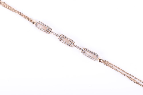 Lot 724 - A yellow metal and diamond bracelet the three...