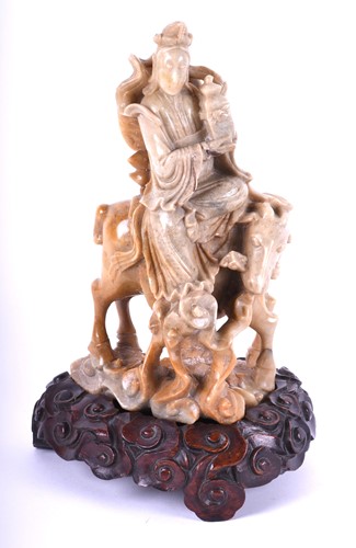 Lot 225 - A Chinese carved soapstone figure of Guan Yin,...