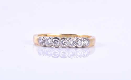 Lot 787 - An 18ct yellow gold and diamond ring the band...