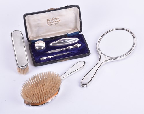 Lot 611 - A three piece silver backed brush set and...
