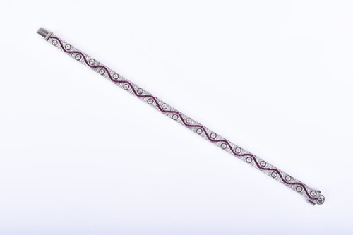 Lot 664 - An Art Deco diamond and ruby bracelet, formed...